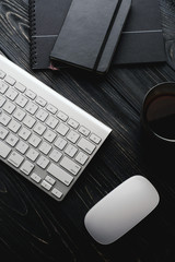 Canvas Print - Modern dark surface wooden office desk table with computer and cup of coffee. Hero Header Concept with Copy space.