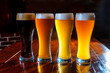 © antonkorobkov - four types of beer: dark, light, red, white. In a dark pub