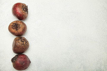 Fresh red beet on white table, empty space for text.