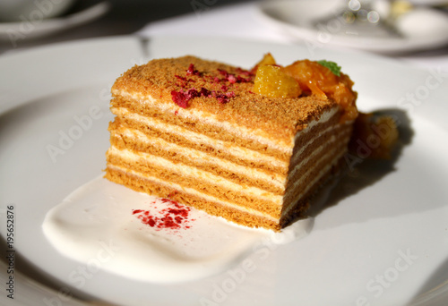 Zdjęcie XXL Makro- fotografia smakowity miodowy tort z pomarańcze