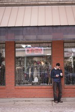 Man Using Mobile Phone Outside The Shop