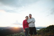 © Rob and Julia Campbell/Stocksy - Fit, active middle age couple hiking together at sunset