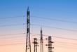 © Pixel Stories/Stocksy - Power poles and power lines at sunset