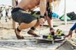 © Lumina/Stocksy - Surfers Doing Board Maintenance