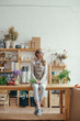 © Laika One/Stocksy - Young florist in flower shop