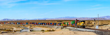 Wide Panorama Of Union Pacific Railroad Locomotive Carrying Long Freight Cars