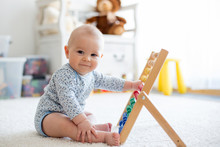 Cute Little Baby Boy, Playing With Abacus At Home