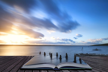 Wall Mural - creative book image of beautiful vibrant sunset landscape image of fleet lagoon in dorset england