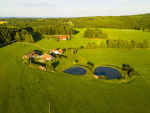 Aerial View Of Fishing Ponds And Farmhouses. System Of Ponds On The Brook. Traditional Fish Farming Agriculture. South Bohemia Countryside From Above. Czech Republic, European Union.