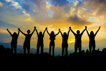 friends silhouette holding hand in hand