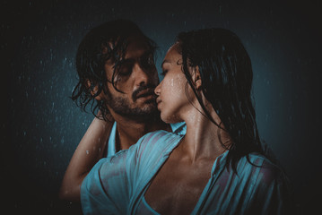 Couple sharing romantic moments under the rain