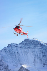 Poster - Red helicopter at Swiss Alpine mountains in winter Gsteigwiler