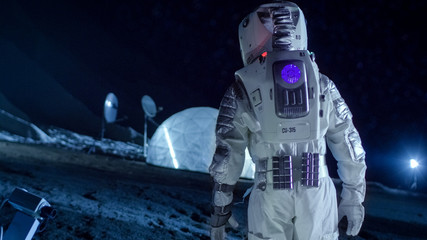 Wall Mural - courageous astronaut in the space suit walks on the surface of the alien planet. exploring newly dis