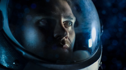 Wall Mural - portrait shot of the courageuos astronaut wearing helmet in space, looking around in wonder. space t