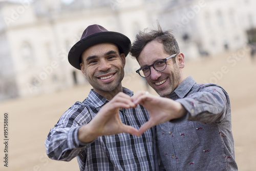 homosexual couple making a heart symbol with their hands. Tablou Canvas