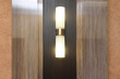 Beautiful vertical sconce on the wall in the hall