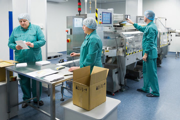 Wall Mural - Pharmaceutical factory workers in sterile environment