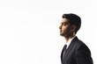 © Carlos David - A profile portrait of a handsome man in suit and tie looking to side  isolated on white studio background