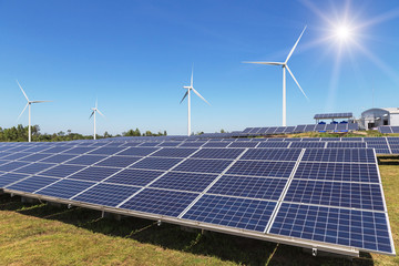 Poster - Rows array of  polycrystalline silicon solar panels and wind turbines generating electricity in hybrid power plant systems station alternative renewable energy from natural 