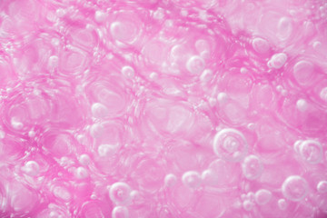Wall Mural - Close up of Air Bubbles in Ice on Pink Background