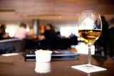 Fototapeta  - a glass of white wine on a table