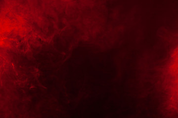 Red smoke or flame texture on a black background. Texture and abstract art