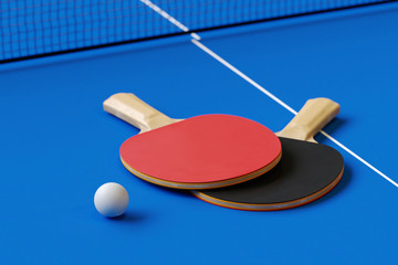 Wall Mural - Two table tennis or ping pong rackets and ball on a table with net 3d illustration