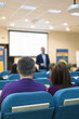 © danmorgan12 - Conferences and Business Meetings Concepts. Mature Experienced Male Presenter Giving a Talk in Front of the Group Of Listeneres During a Conference.