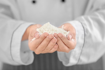 Poster - Female chef holding white wheat flour, closeup