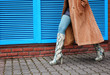 Stylish woman in snakeskin shoes walking down the street