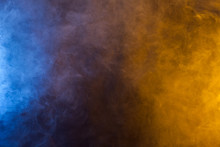 Blueand Yellow Smoke In Dark Background. Texture And Desktop Picture