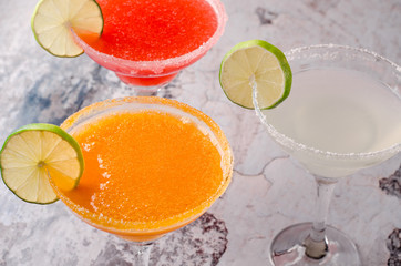 two classic and strawberry margarita, white and red alcoholic cocktail with decoration of salt on the glass with fresh lime, lemon, daiquiri on background restaurant. Bar alcohol menu, sweet drink