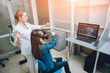 © romaset - Ophthalmology doctor checks the girl's vision with the help of virtual reality goggles.