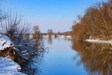 Water surface of the river at the sunset of winter day