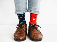 Male Legs In Bright, Colorful Socks And Stylish, Vintage Shoes On A White Background. Lifestyle, Fashion, Fun
