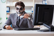 © Elnur - Businessmsn with scary face mask working in office