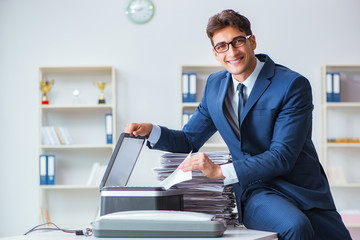 Businessman making copies in copying machine