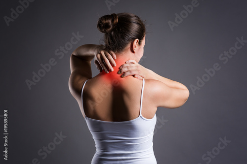Fotografía Neck pain, woman with backache on gray background