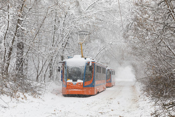 Wall Mural - Heavy snowfall in Moscow. Snow-covered roads and damaged power lines during a snowfall. Collapse of public transport and stopped tram