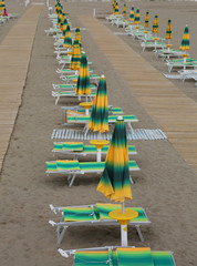 Wall Mural - yellow and green loungers and umbrellas  along an Italian beach