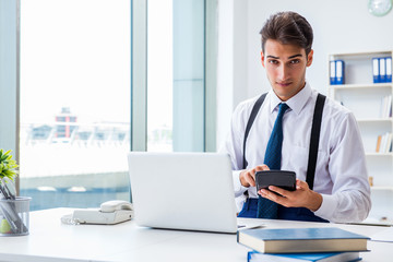 Wall Mural - Young stylish businessman working in the office