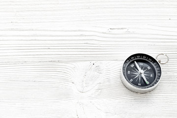 Wall Mural - Direction concept with compass on white wooden background top view mockup