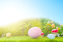 Colorful Easter Eggs And One Big Pink Easter Egg On Spring Green Grass