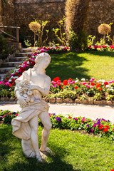 An ancient figure in a public garden.Giardini Capri, Italy