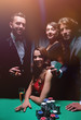 © ASDF - Upper class friends gambling in a casino.