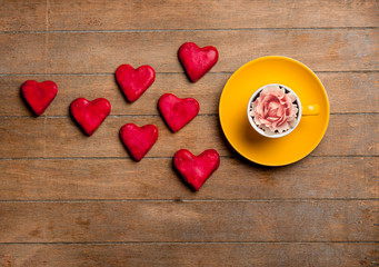 Wall Mural - Cup of tea with rosebud in it and cookies