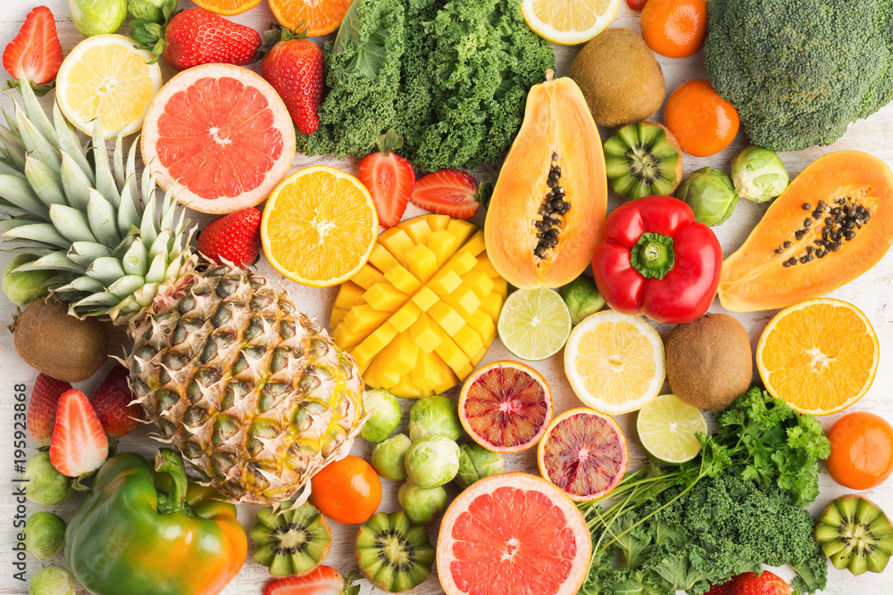 Fruits and vegetables rich in vitamin C background pattern, oranges mango grapefruit kiwi kale pepper pineapple lemon sprouts papaya broccoli, on white table, top view, selective focus - obrazy, fototapety, plakaty 