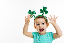Excited Child With St.Patrick's Day Clover Head Decoration And Open Mouth