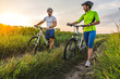 © sergo321 - young man and woman are driving their bicycles on their way to the field in the summer.