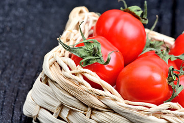 Poster - Cherry tomatoes in a rustic wicker on table